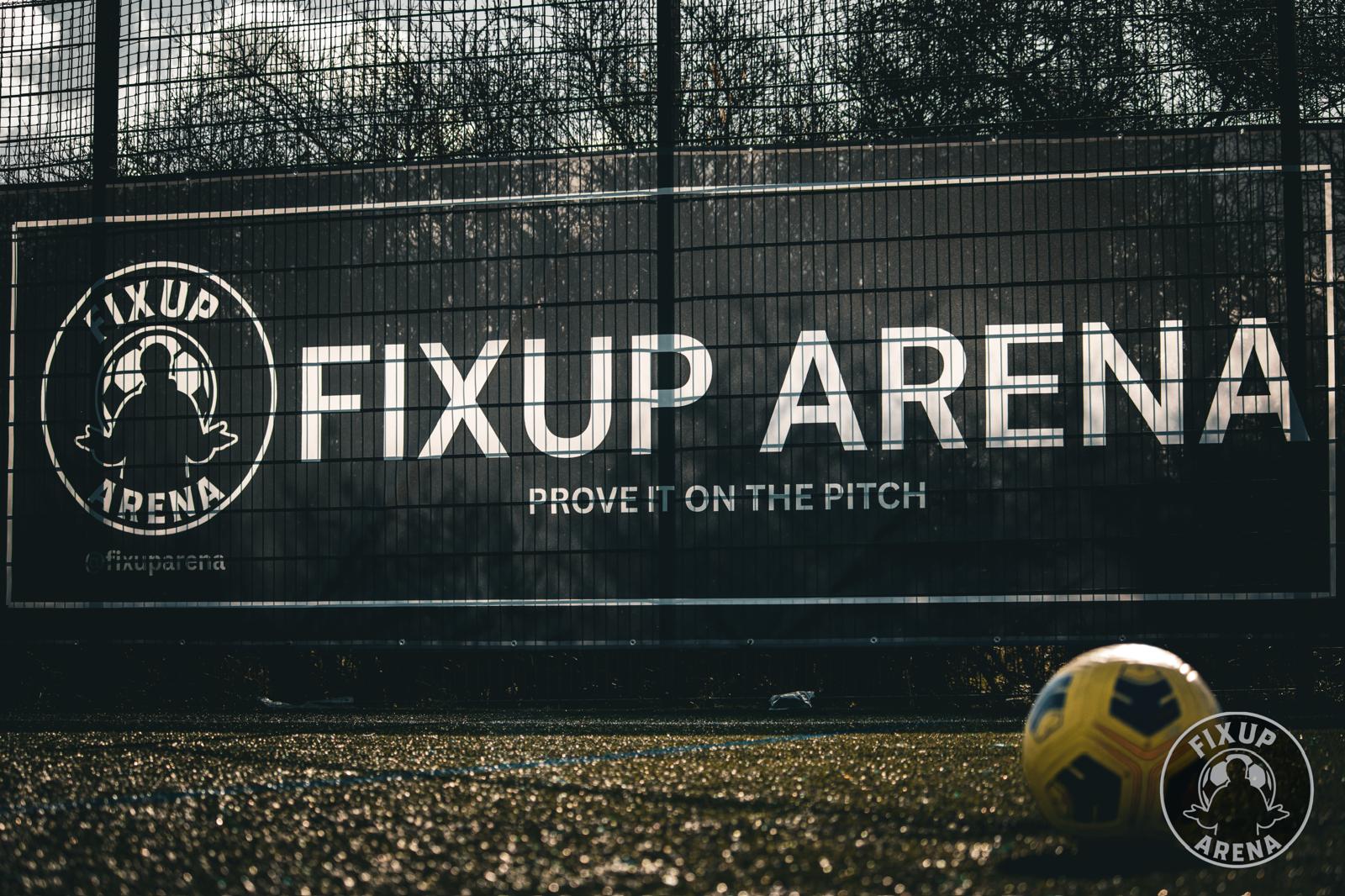 FixUp Arena pitch-side banner reading Prove It On The Pitch with a matchball on the turf
