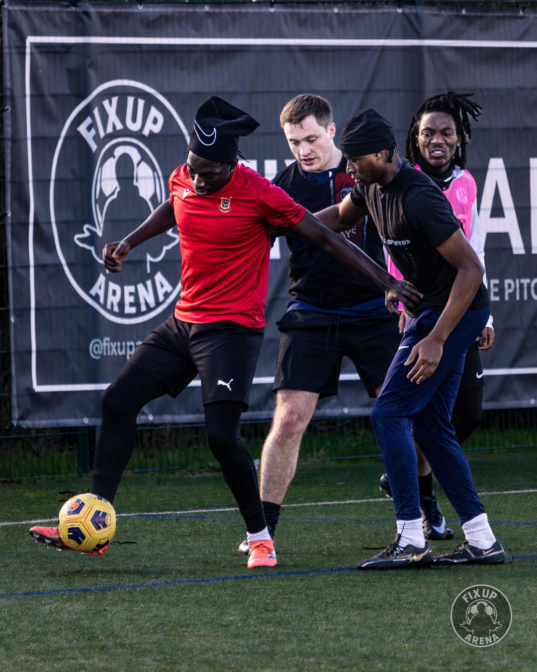 Players battling for possession in front of the FixUp Arena banner at the first tournament
