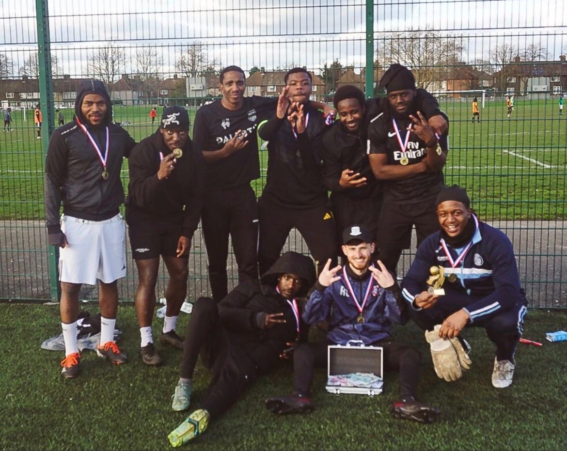 Brixton FC celebrating with their medals and the cash prize after winning the first FixUp Arena tournament at Castle Green, Dagenham
