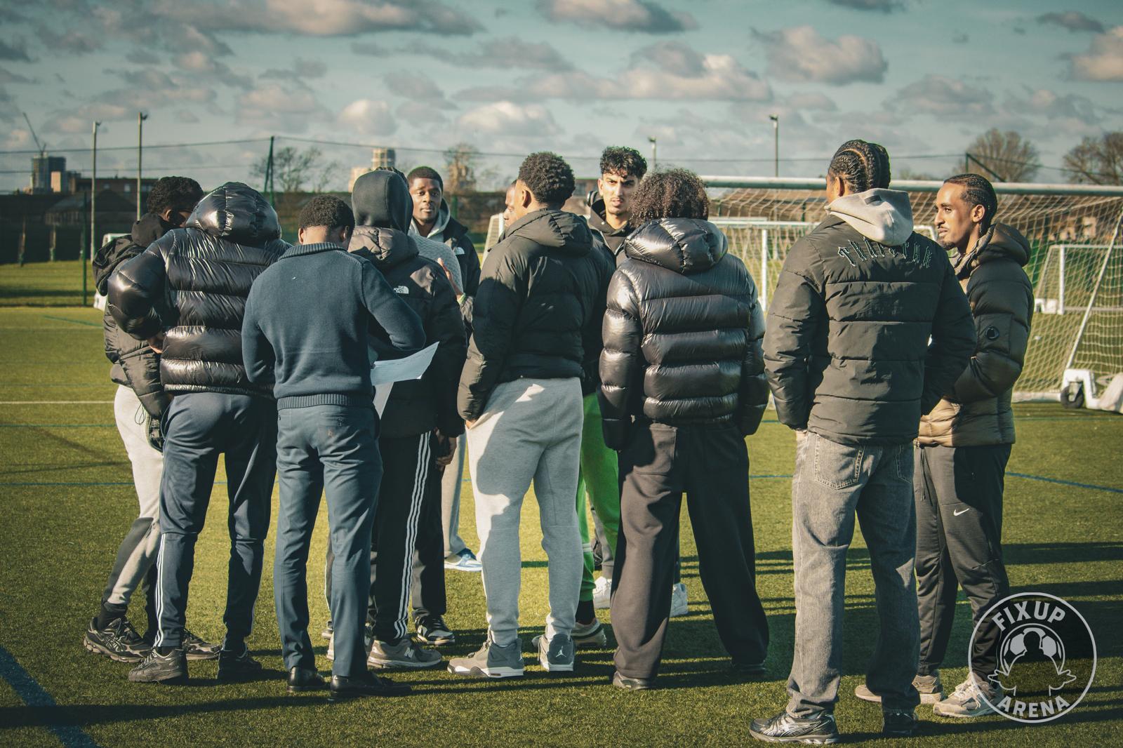 Team huddle on the pitch at the first FixUp Arena tournament at Castle Green, Dagenham